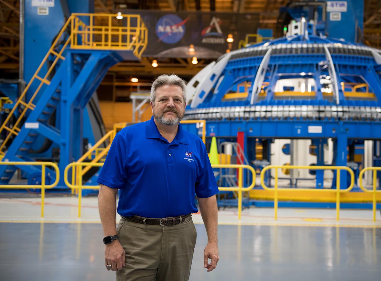 Robert Champion - Director NASA Michoud Assembly Facility stands in front of the Robotic Weld tool in BLDG 103.